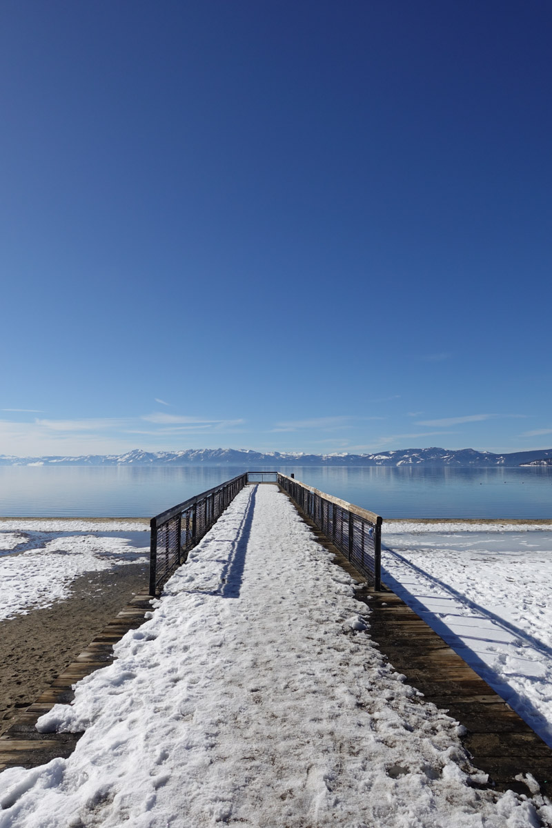 Lake Tahoe Pier in the winter looking over the calm morning waters.